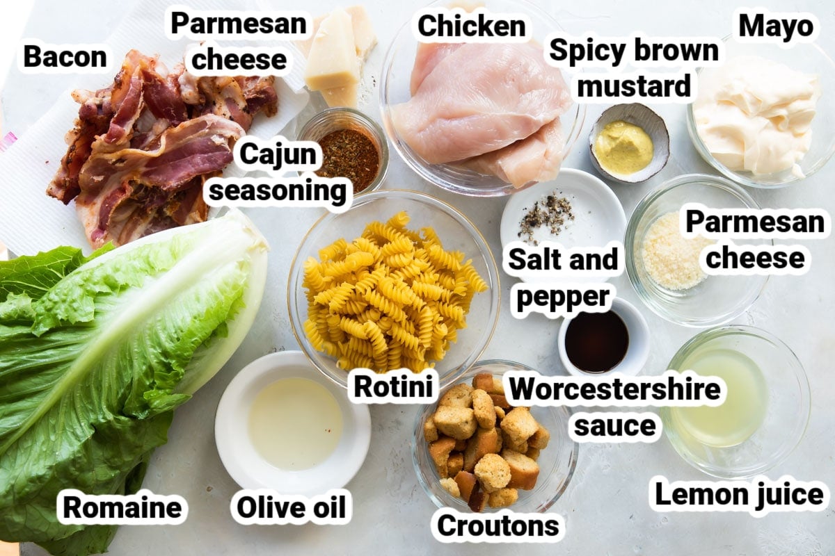 Labeled ingredients for chicken Caesar pasta salad.