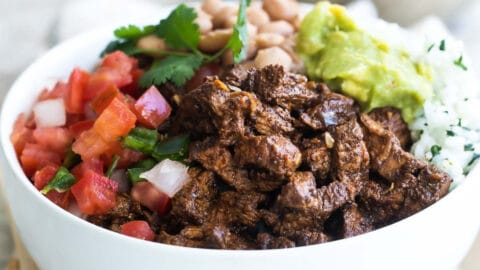 A bowl of Chipotle steak, pinto beans, cilantro-lime rice, and pico de gallo.