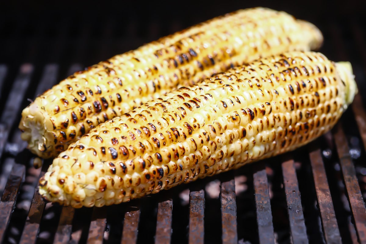 2 ears of corn on a gas grill.