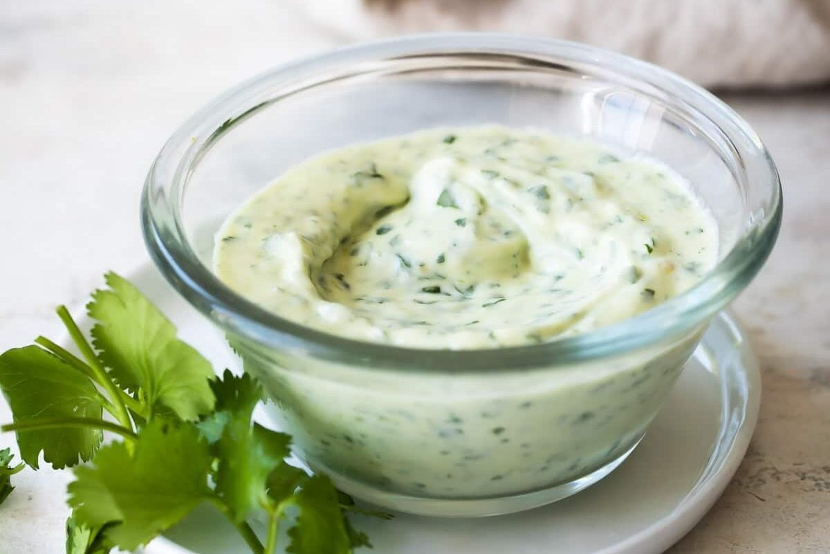A clear dish of cilantro lime dressing.