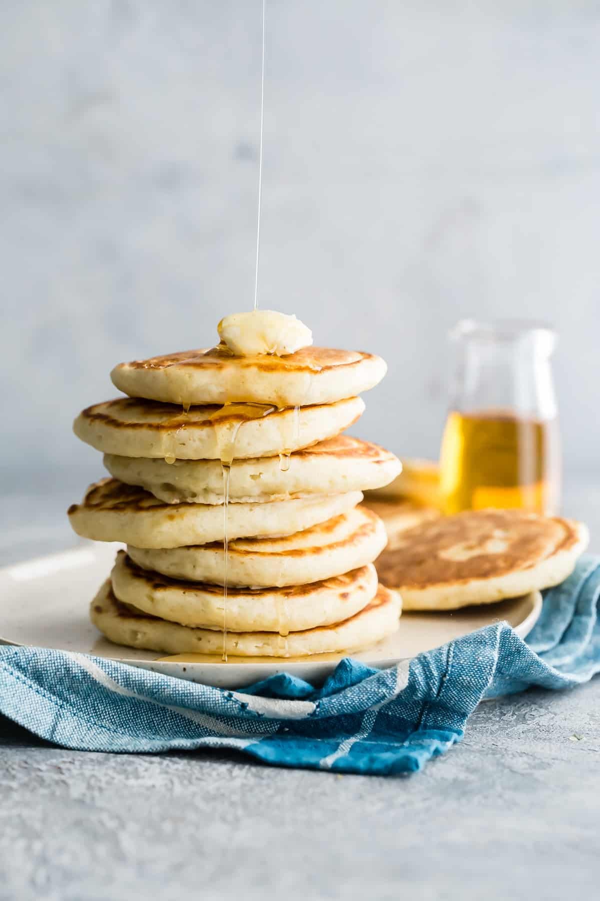 A stack of homemade pancakes on a plate.