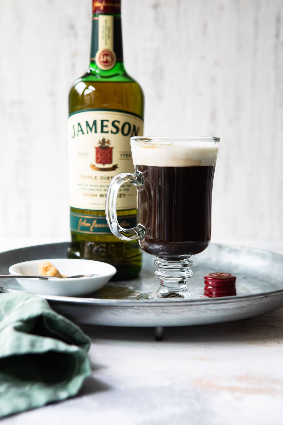 A tray with Irish Coffee and a bottle of Jameson Irish whiskey.