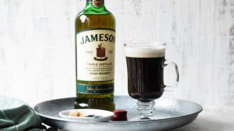 A tray with Irish Coffee and a bottle of Jameson Irish whiskey.