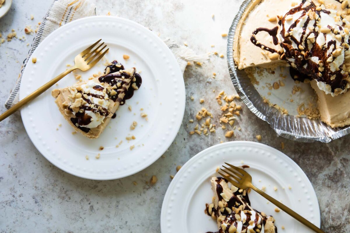 Two slices of peanut butter pie on white plates.