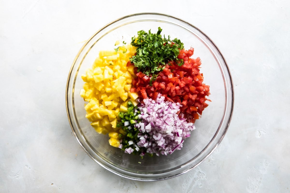 Ingredients in a bowl for pineapple salsa.