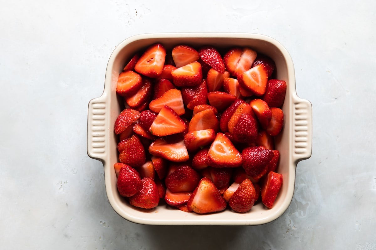Strawberries in a baking dish for cobbler.