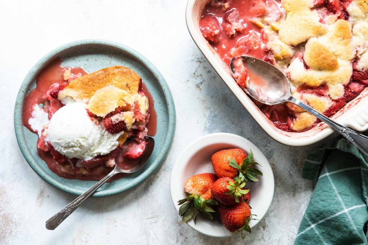 A dish of strawberry cobbler with ice cream.