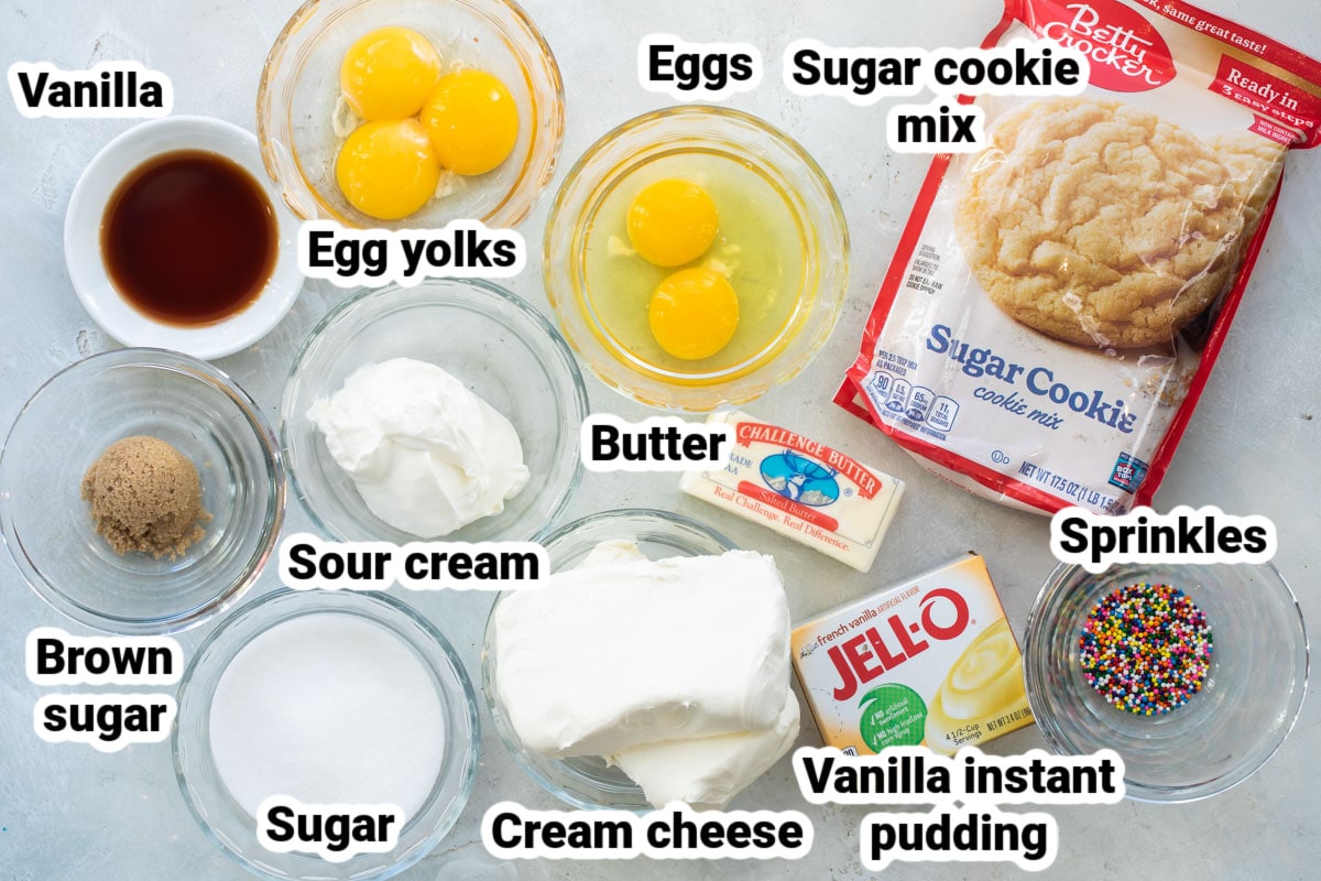 Labeled ingredients for sugar cookie cheesecake bars.