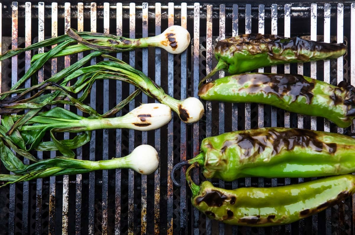 Fennel and peppers roasting on a grill.