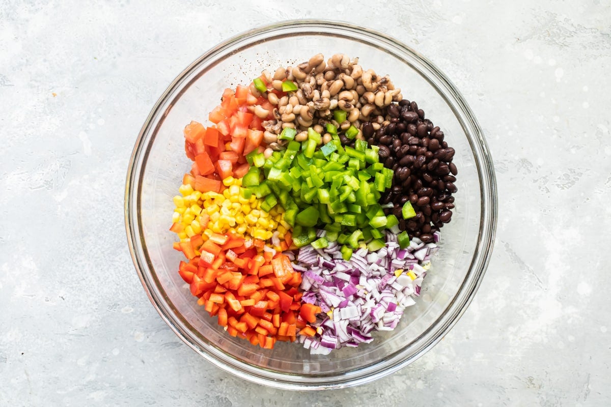 Cowboy caviar ingredients in a bowl before being mixed.
