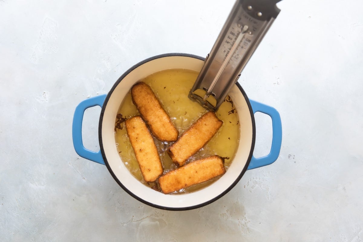 Deep-frying French toast sticks in a Dutch oven.