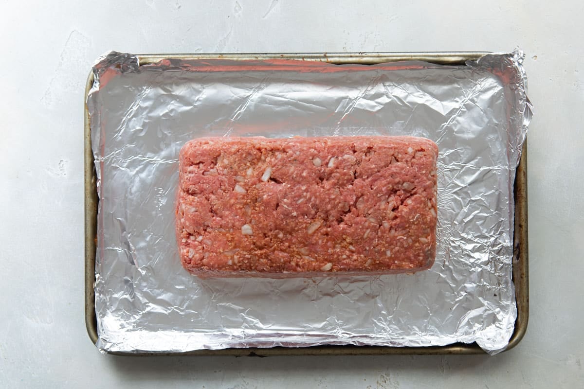 Meatloaf on a baking sheet before being baked.