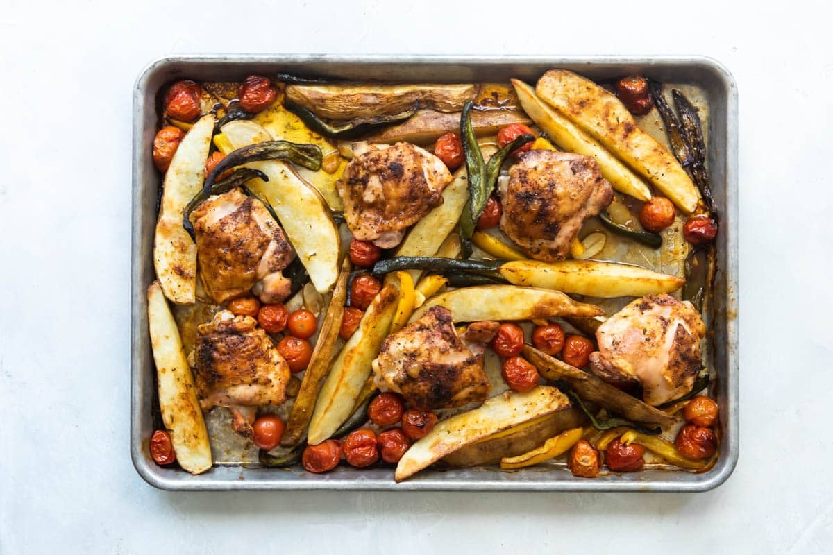 Paprika chicken and vegetables on a baking sheet.