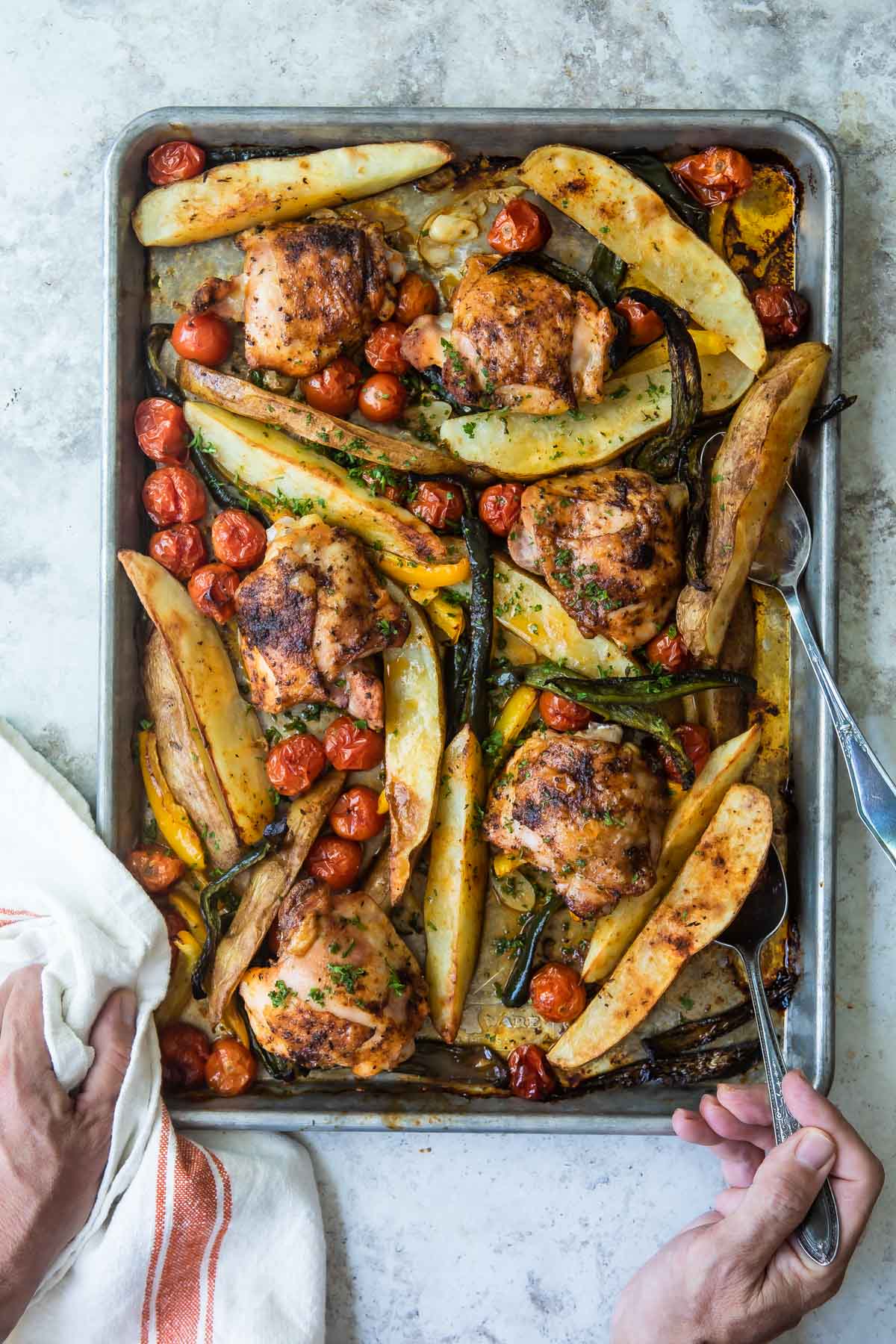 Paprika chicken and vegetables on a baking sheet.