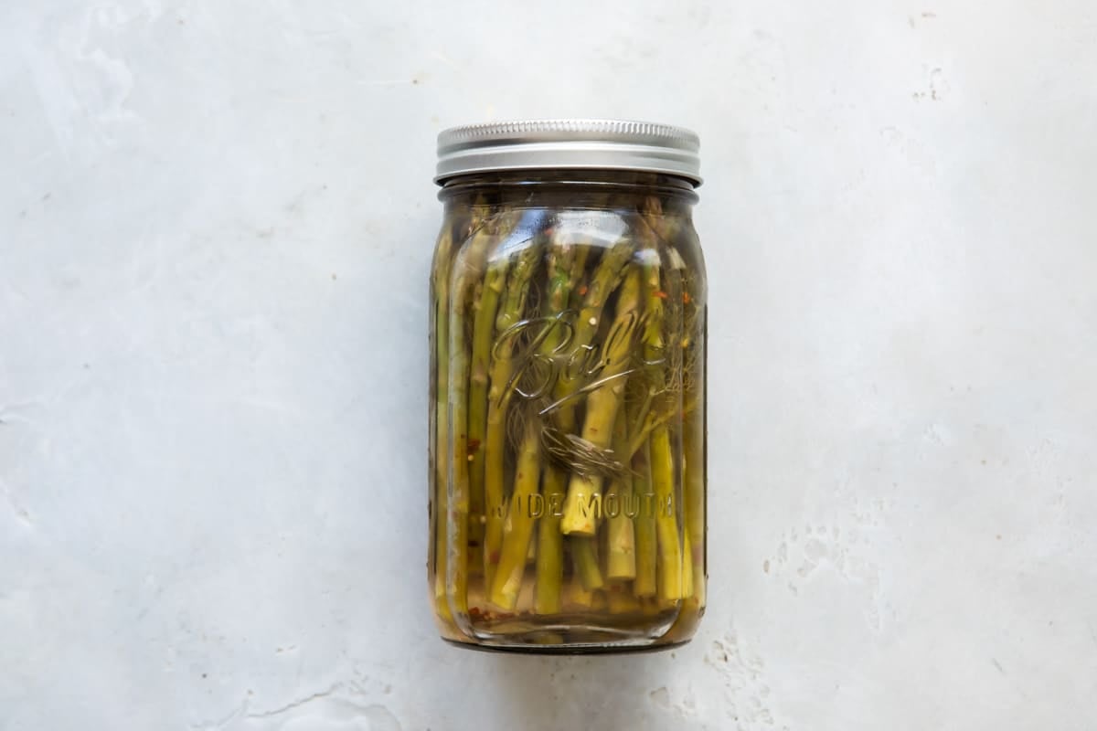 Pickled asparagus in a jar.