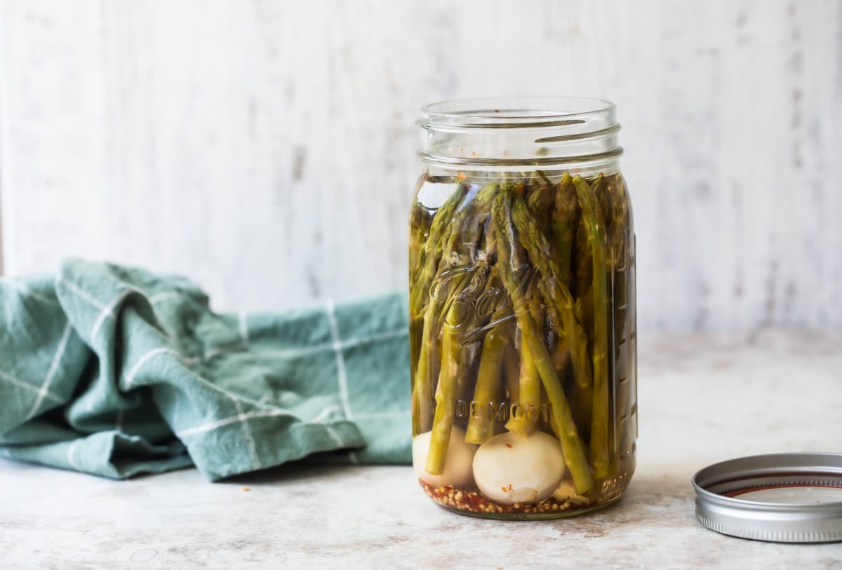 A jar of pickled asparagus.