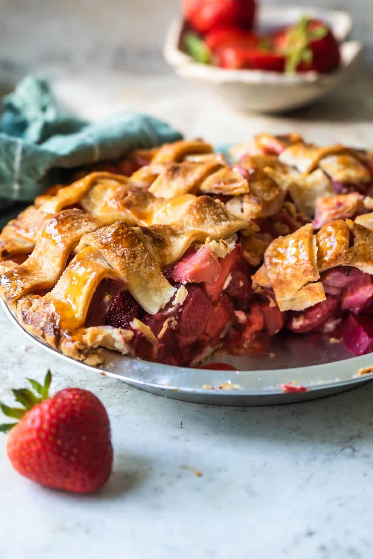 Strawberry rhubarb pie in a silver pie pan.