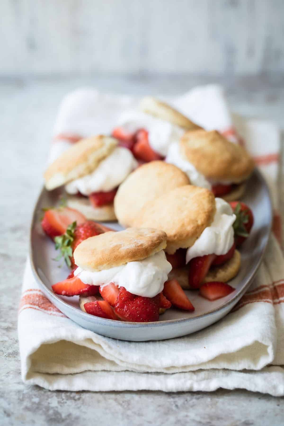 Strawberry shortcakes on a gray serving platter.