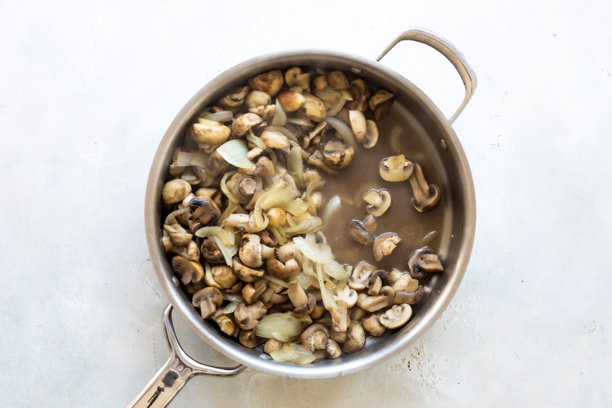 A skillet of mushrooms and onions.