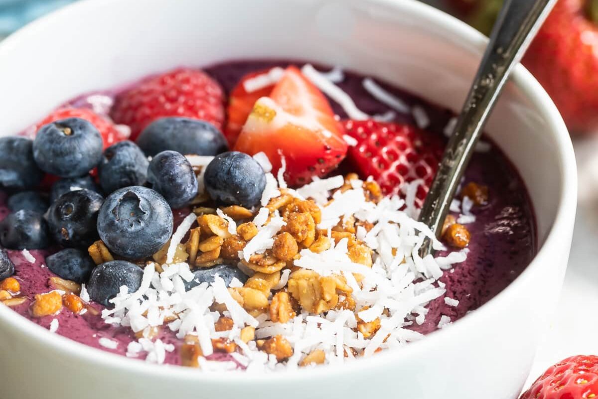 Easy acai bowl in a white dish with a spoon.
