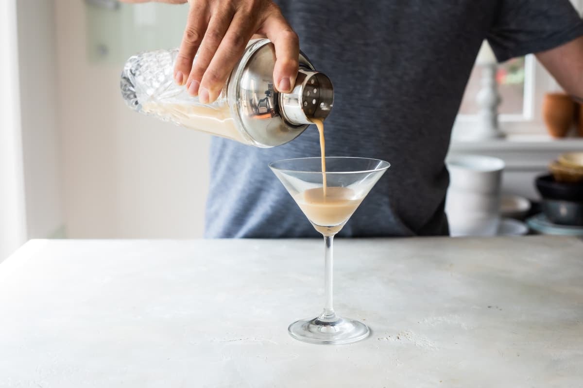 Making an espresso martini in glass.