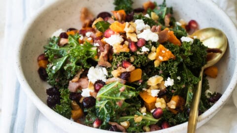 A white bowl filled with kale salad.