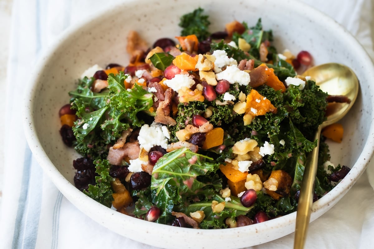 A white bowl filled with kale salad.
