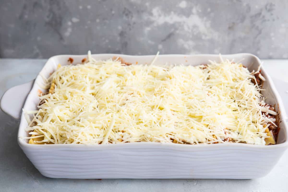 The best make ahead lasagna in a white baking dish before being baked.