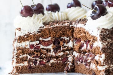 A black forest cake on a marble platter.
