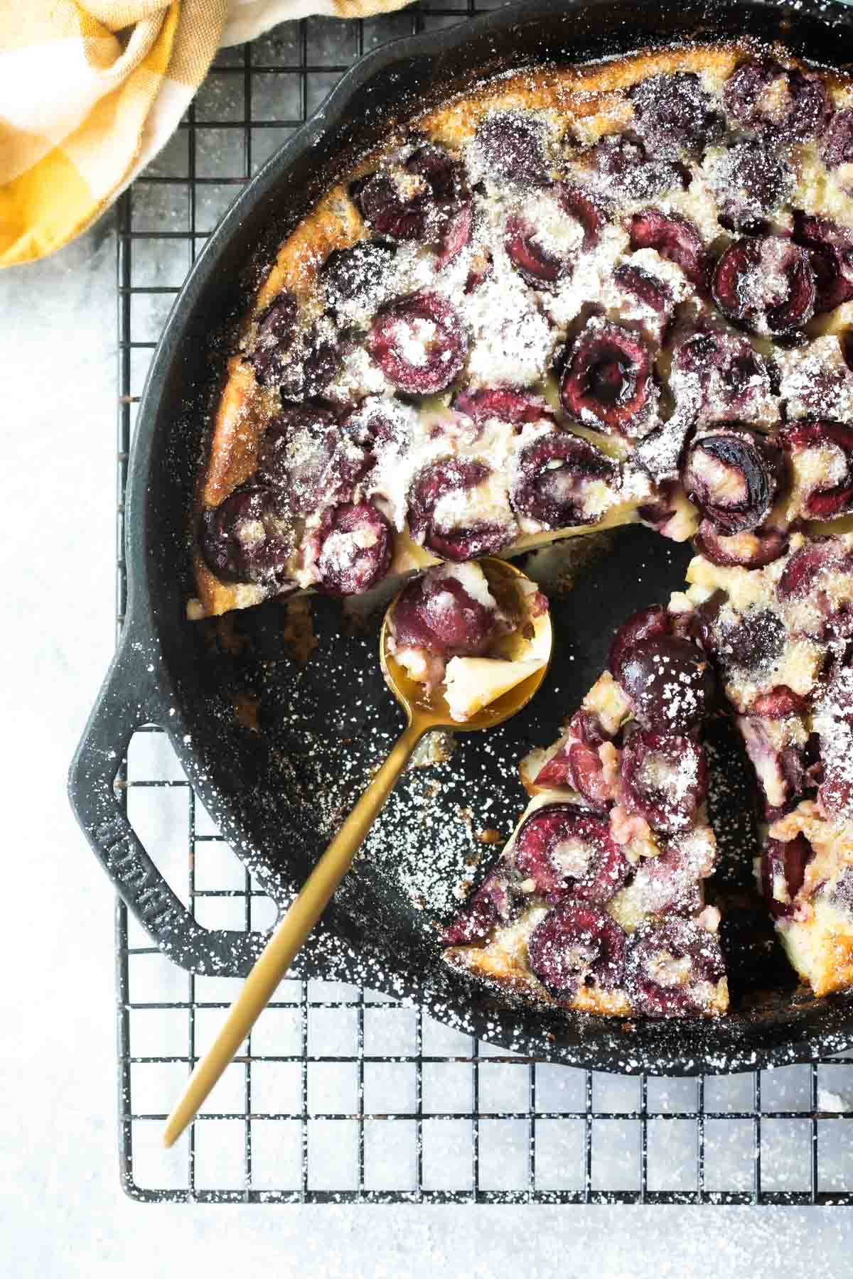 A cast iron skillet with Cherry Clafoutis.