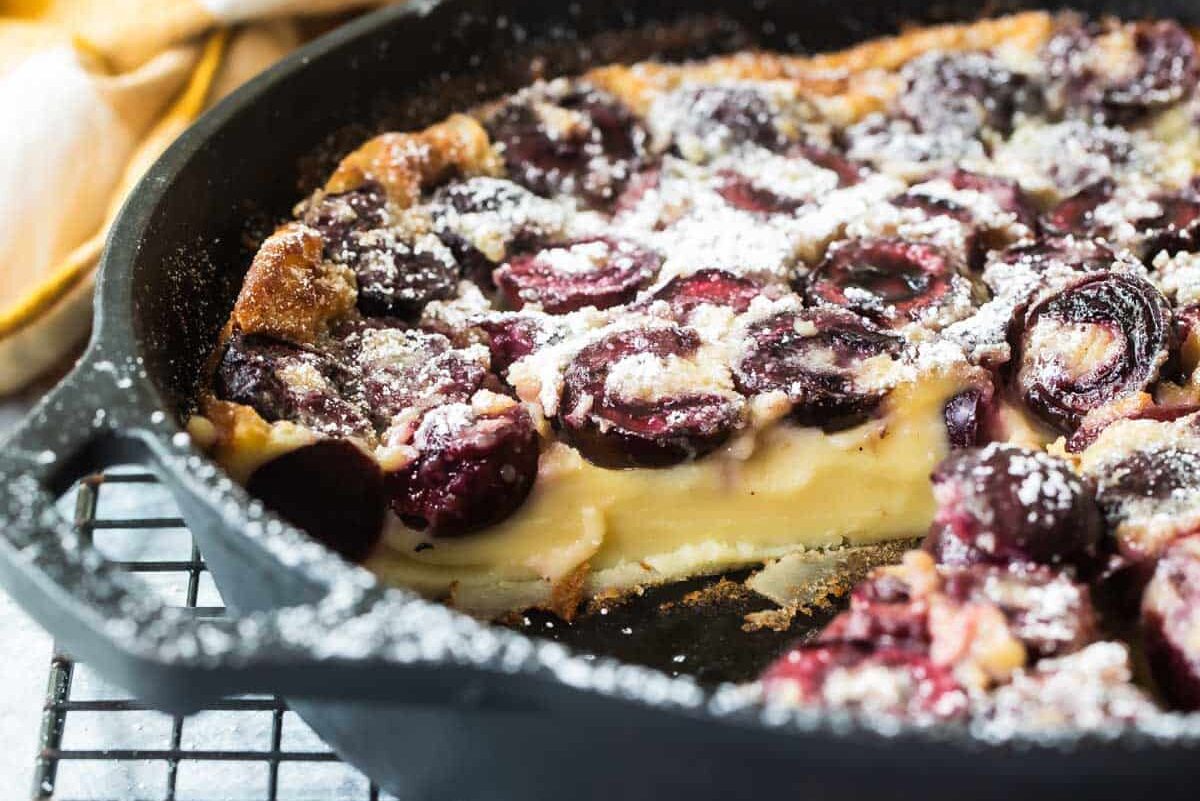 A cast iron skillet with Cherry Clafoutis.