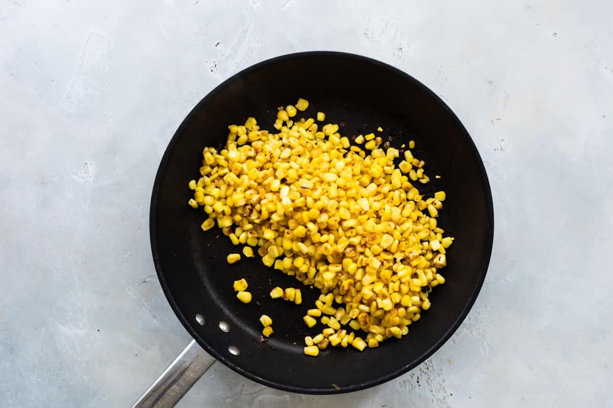Toasting frozen corn in a skillet.