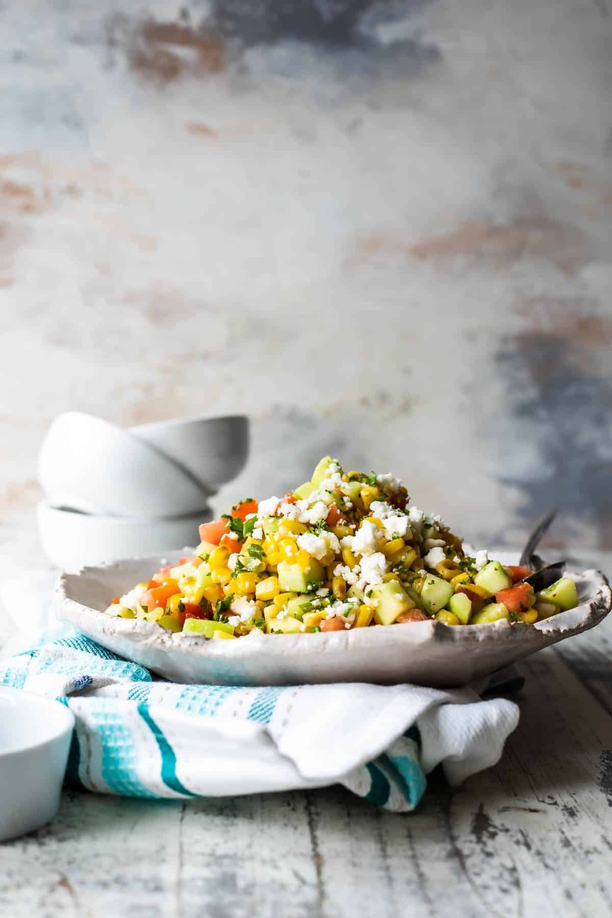 A serving platter of Corn Salad on a blue and white napkin.