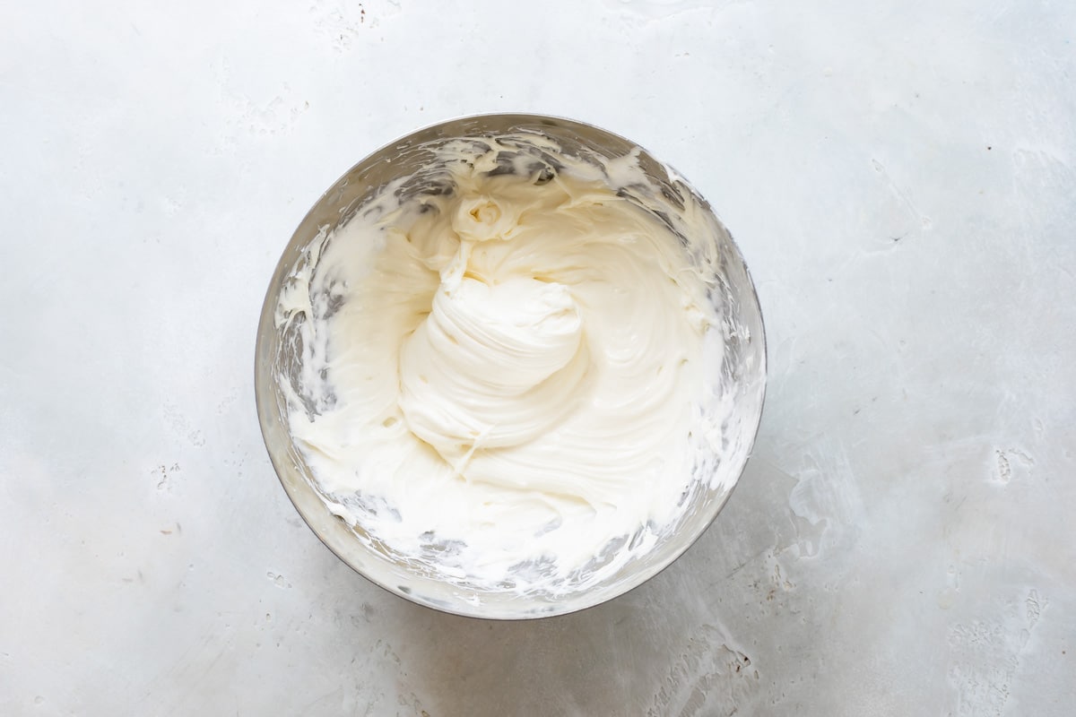 Cream cheese and marshmallow fluff beaten in a mixing bowl.