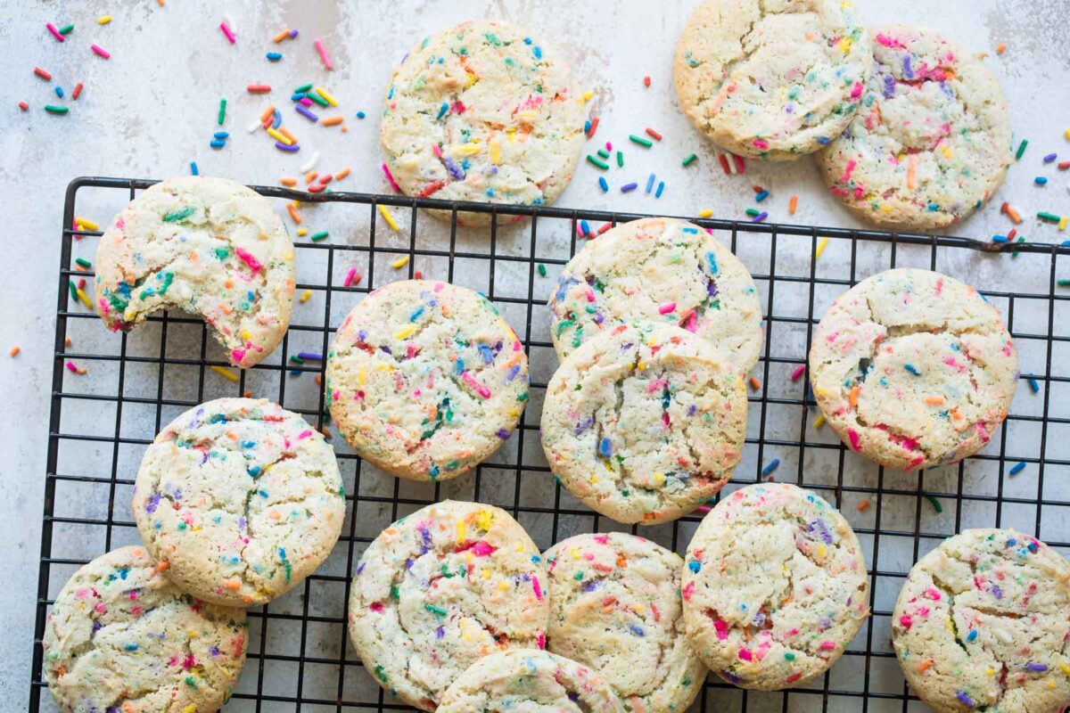 A cooling rack full of funfetti cookies.
