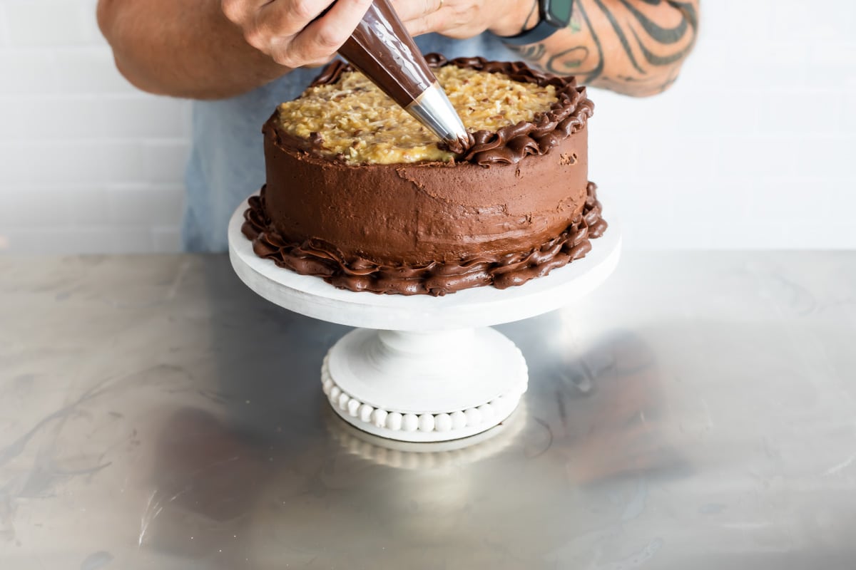 Frosting a German Chocolate Cake.