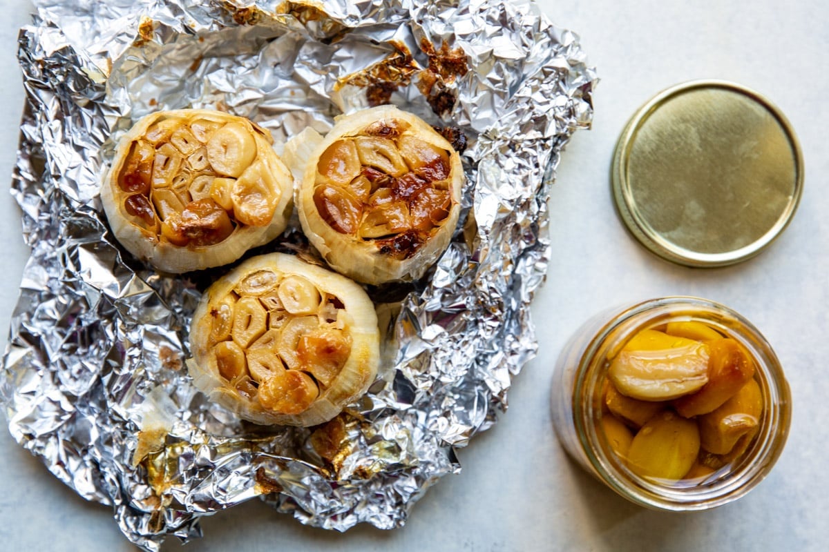 3 bulbs of roasted garlic in an open foil packet.