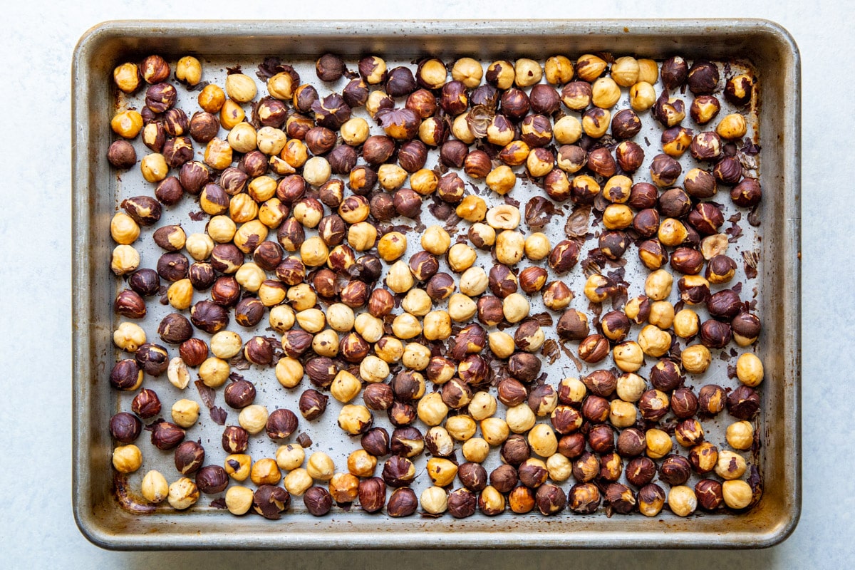 Hazelnuts roasted on a baking sheet.
