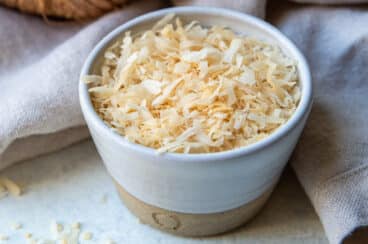 A bowl of toasted coconut.
