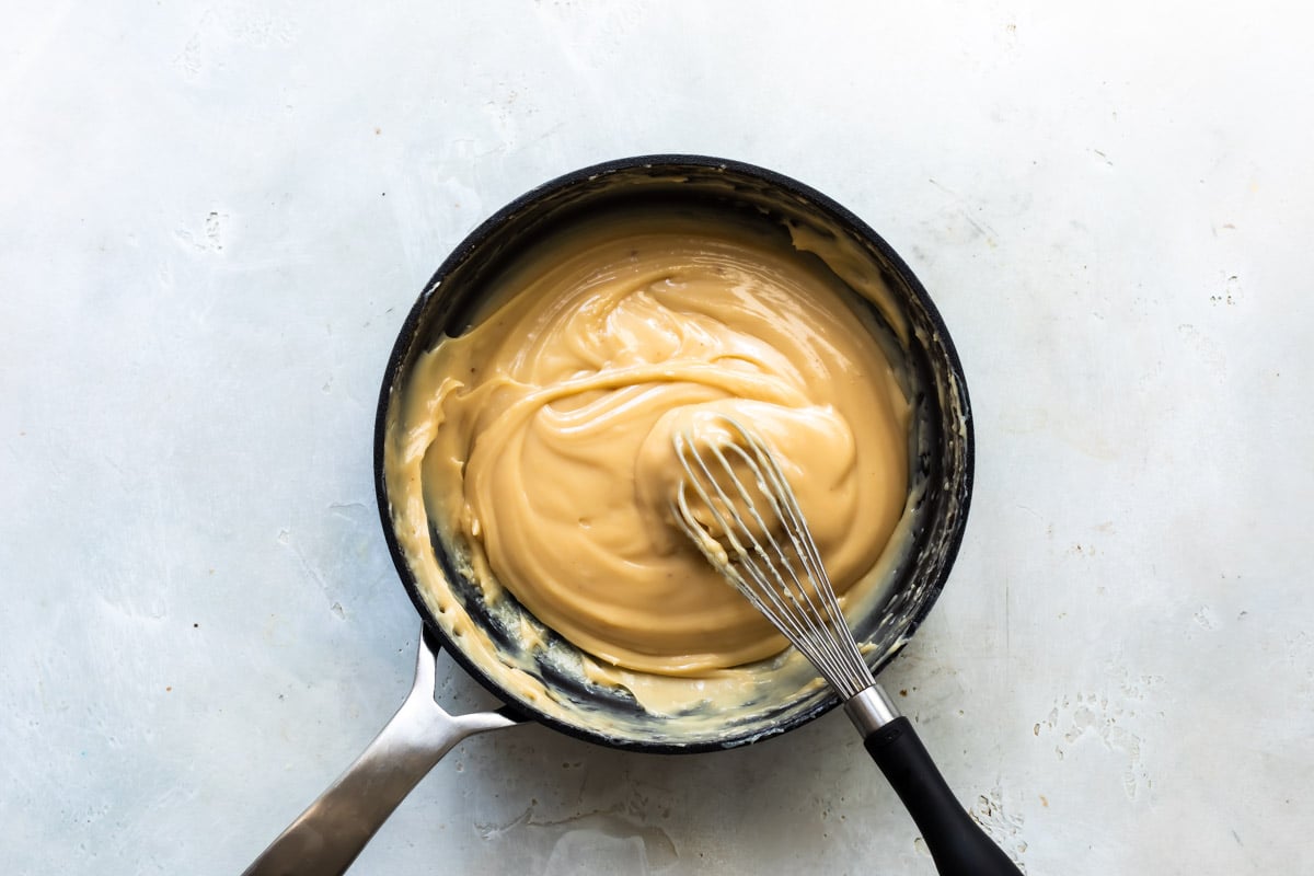 Cooking caramel sauce in a skillet.