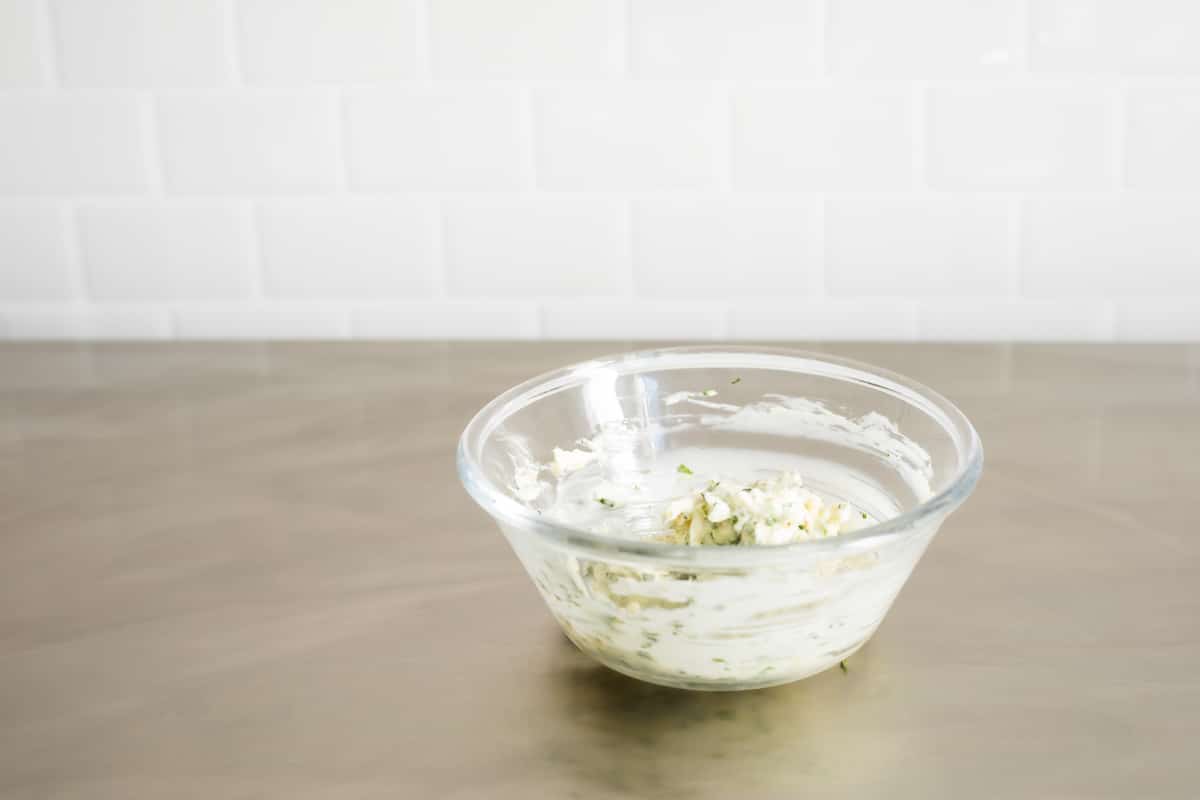 A bowl of compound butter with shallots and thyme.