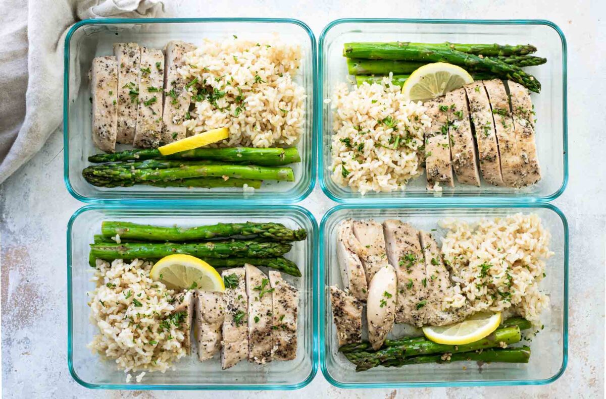 4 containers of lemon pepper chicken, brown rice, and roasted asparagus.