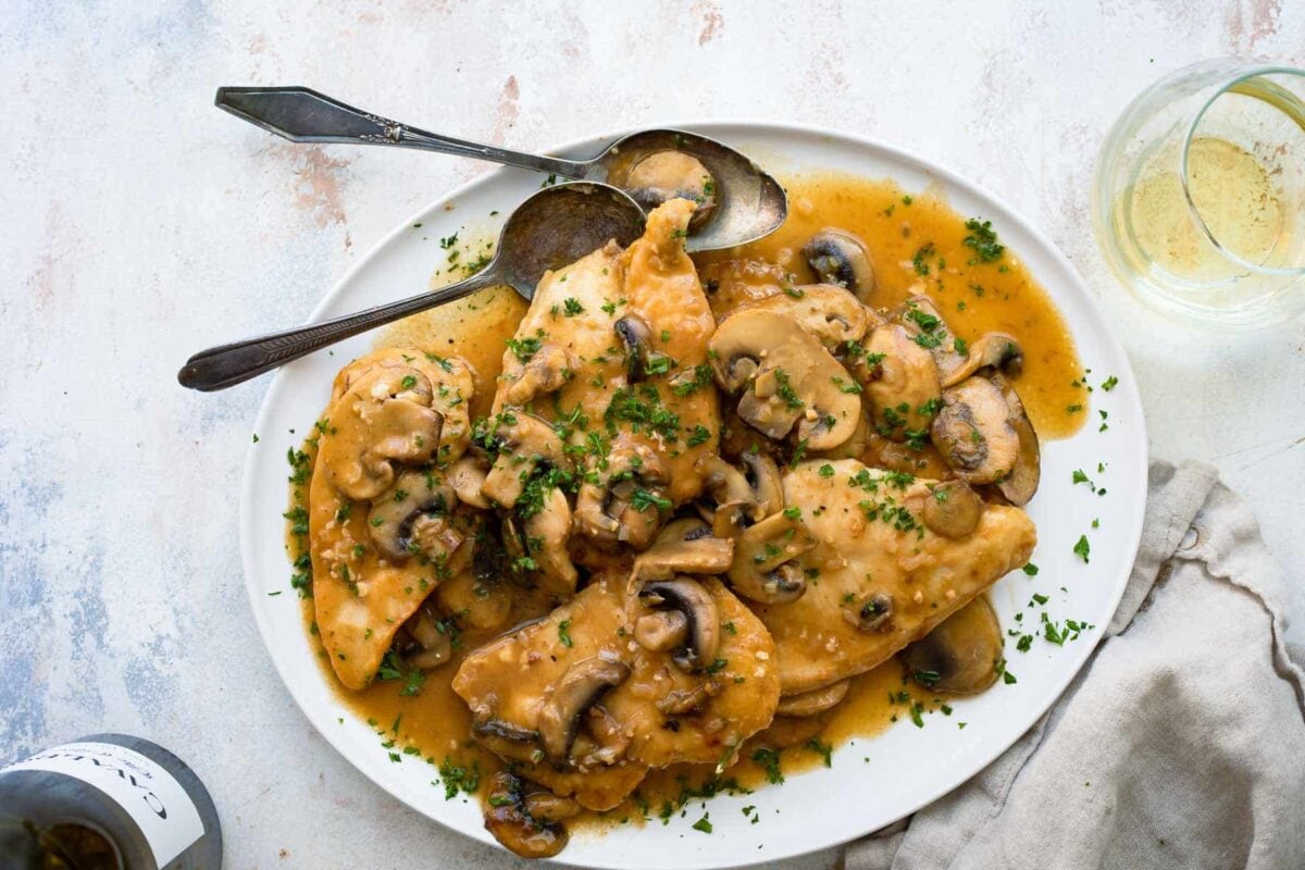 A platter of Chicken Marsala with mushrooms.