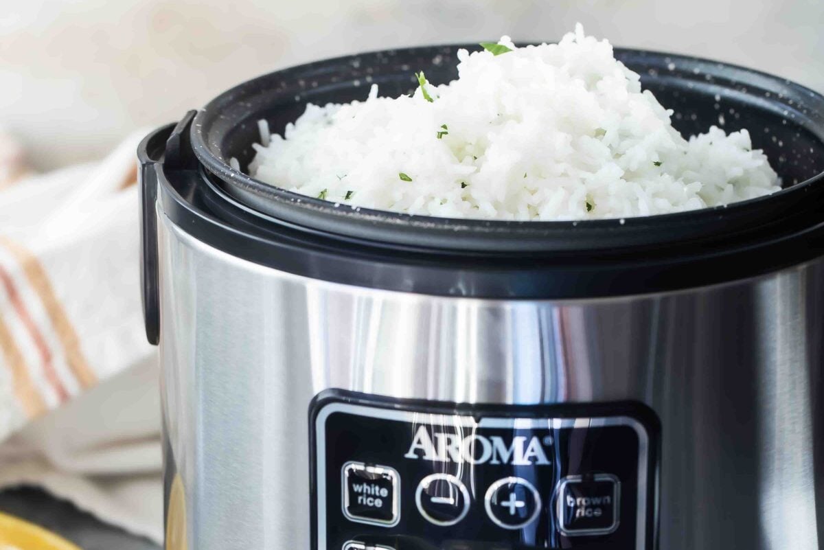 A rice cooker full of white rice.