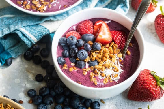 An easy acai bowl topped with coconut, nuts, and berries.