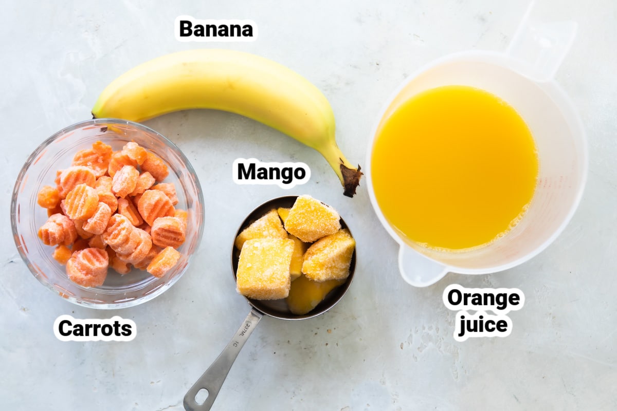 Labeled ingredients for a mango carrot smoothie.