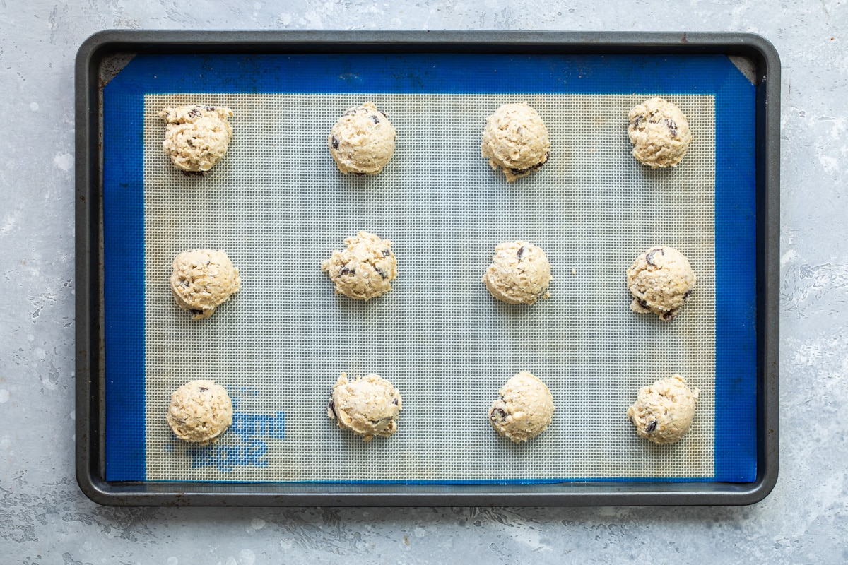 Oatmeal raisin cookie dough on a baking sheet.
