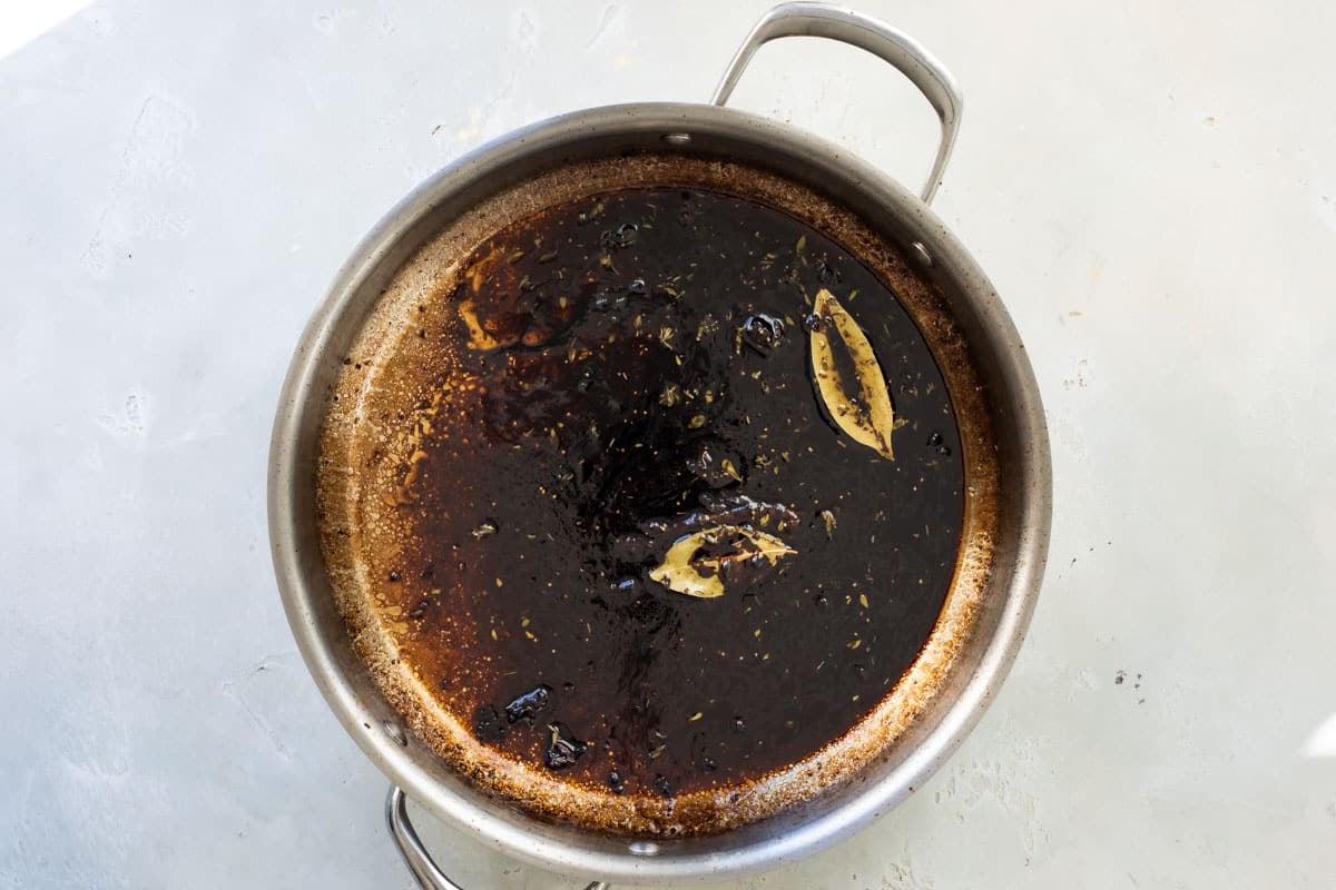 Balsamic glaze being made in a silver skillet.