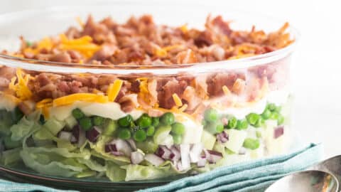 Seven layer salad in a glass dish.