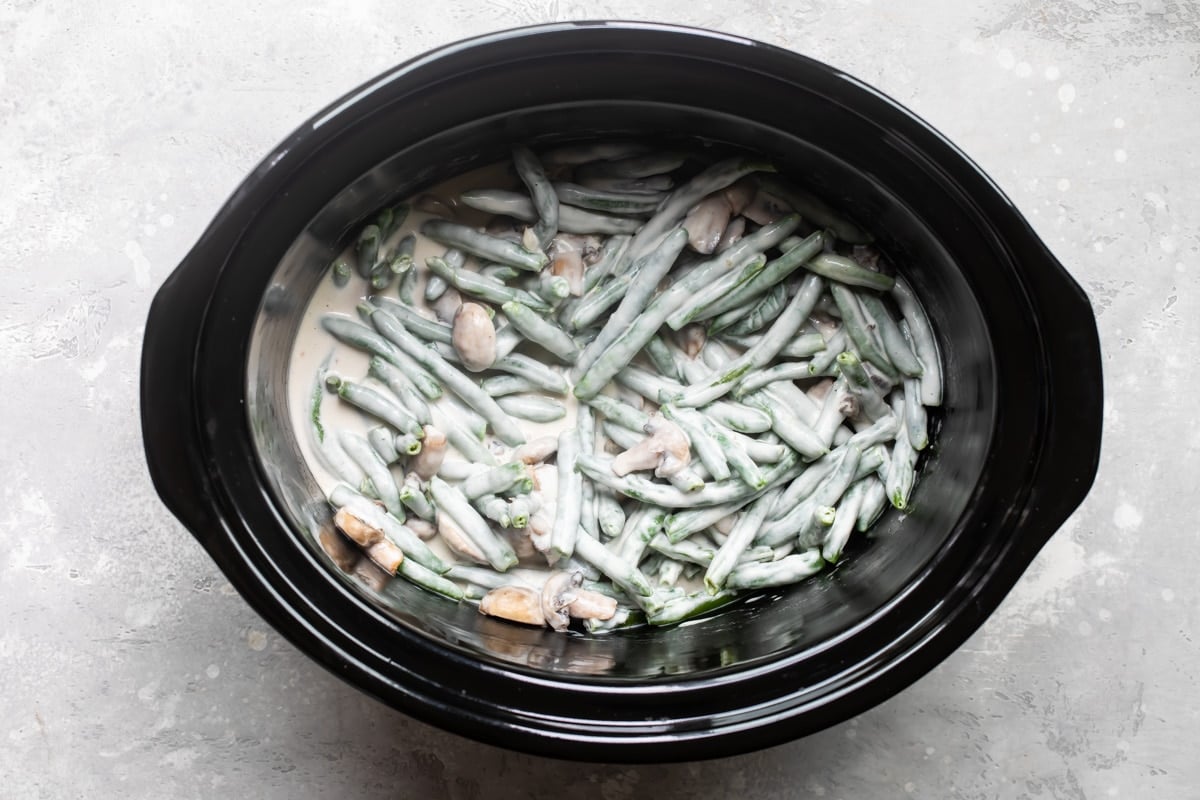 A slow cooker full of green bean casserole.